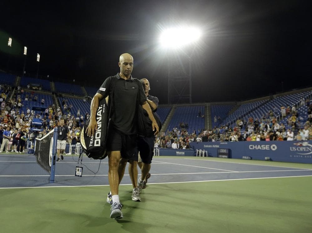 American James Blake, who recently announced his retirement, walks off the court following his loss at the U.S. Open. (Darron Cummings/AP)