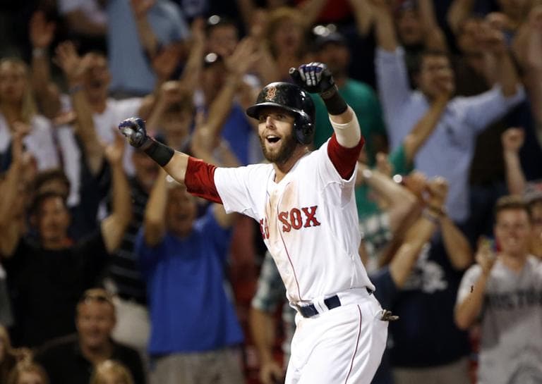 Dustin Pedroia celebrates as he scores the winning run on a single by Stephen Drew in the 15th inning against the Seattle Mariners. (AP)
