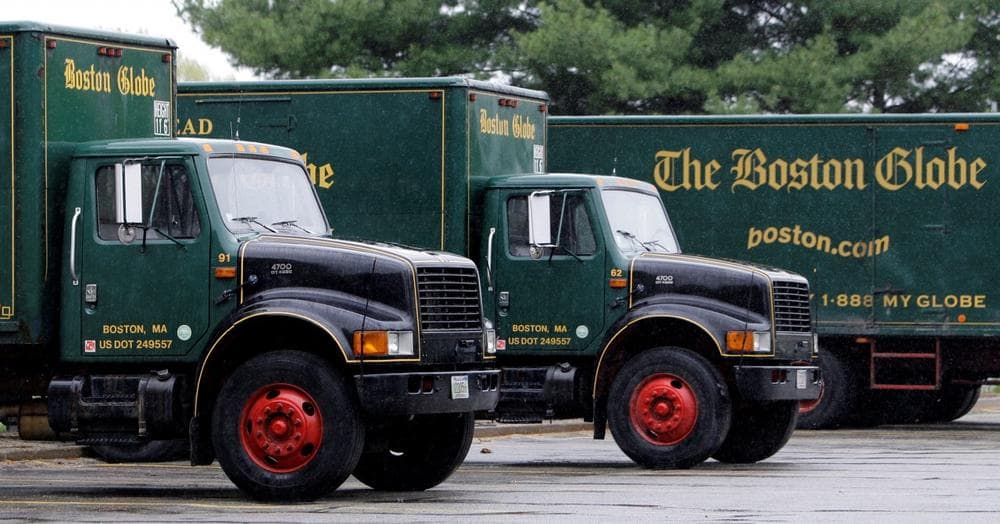 Boston Globe delivery trucks sit parked at their printing plant in Billerica, Mass. (Charles Krupa/AP)
