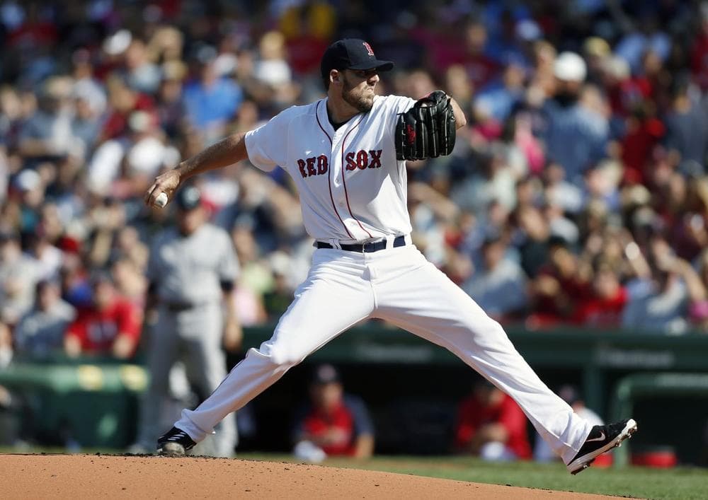 Red Sox's John Lackey pitches in the first inning of a baseball game against the New York Yankees in Boston, Saturday. (AP Photo/Michael Dwyer)