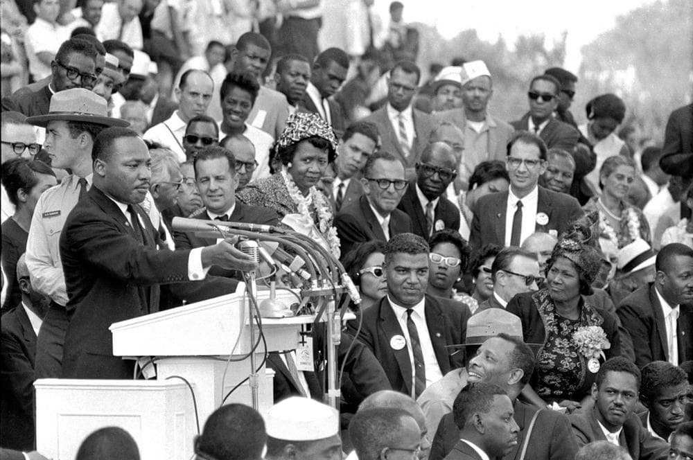 In this Aug. 28, 1963 file photo, the Rev. Dr. Martin Luther King Jr., head of the Southern Christian Leadership Conference, speaks to thousands during his &quot;I Have a Dream&quot; speech in front of the Lincoln Memorial for the March on Washington for Jobs and Freedom in Washington. Actor-singer Sammy Davis Jr. is at bottom right. It has been cited as one of America's essential ideals, its language suggestive of a constitutional amendment on equality: People should &quot;not be judged but he color of their skin but by the content of their character.&quot; Yet 50 years after the King's monumental statement, there is considerable disagreement over what this quote means when it comes to affirmative action and other measures aimed at helping the disadvantaged. (AP Photo)