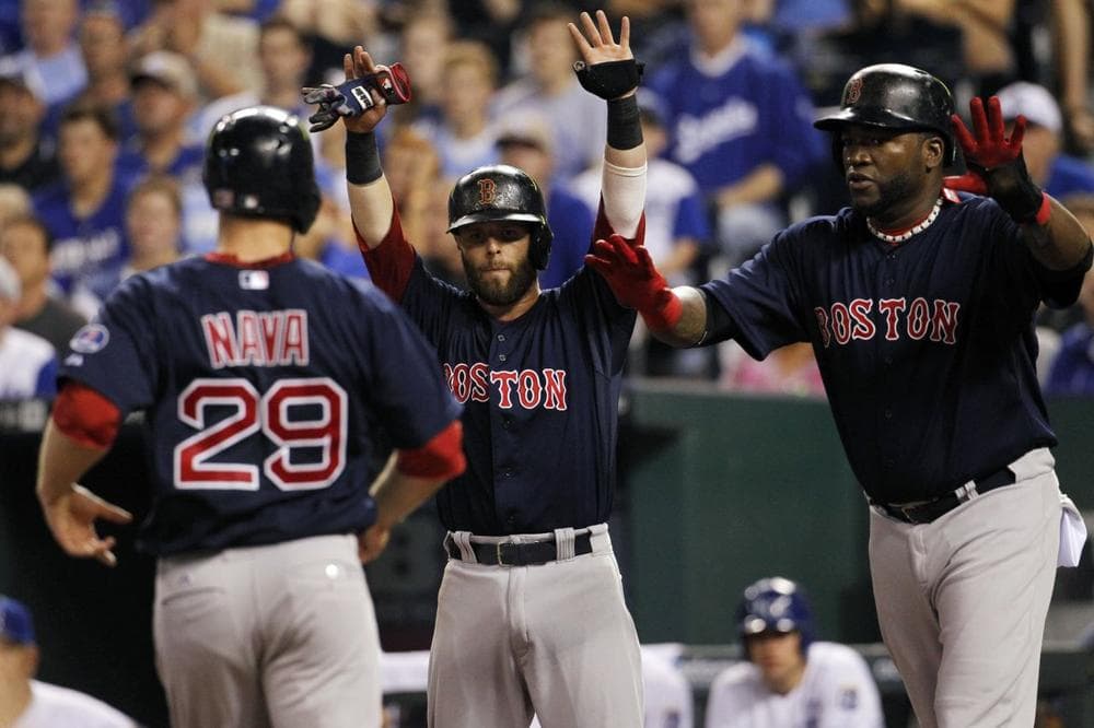 Boston Red Sox's Daniel Nava, left is greeted at home plate by Dustin Pedroia, center, and David Ortiz after all three scored on a Mike Napoli double in the fourth inning of a baseball game against the Kansas City Royals at Kauffman Stadium in Kansas City, Mo., Friday. (AP Photo/Colin E. Braley)