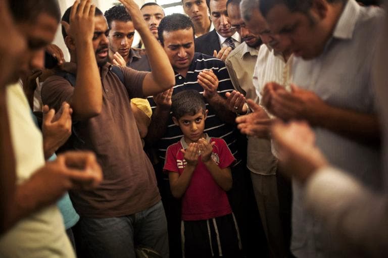 A son of the late Ammar Badie prays during his father's funeral in al-Hamed mosque in Cairo's Katameya district on Sunday, Aug. 18, 2013. Badie, the son of Muslim Brotherhood's spiritual leader Mohammed Badie, was killed by Egyptian security forces Friday during clashes in Cairo's Ramses Square. (AP)