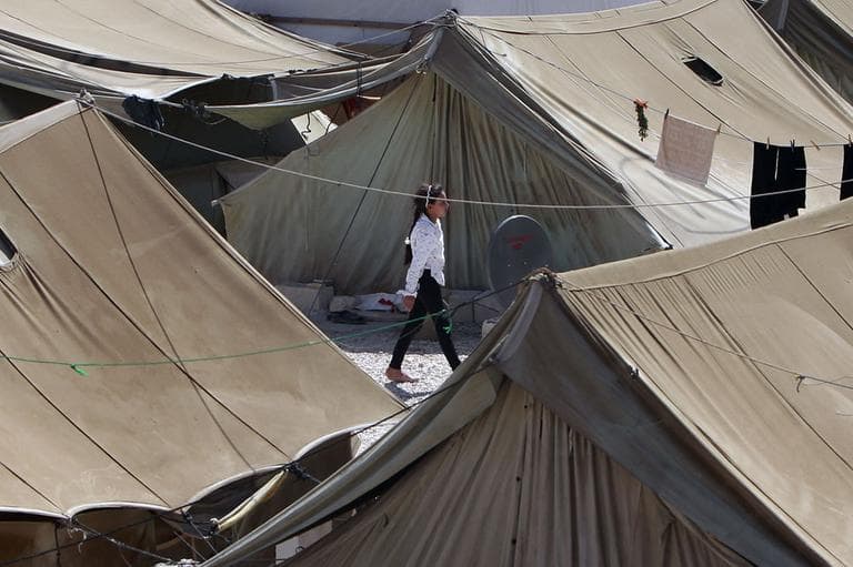 A Syrian refugee girl walks at a temporary refugee camp in the eastern Lebanese town of Marj near the border with Syria, Lebanon, Wednesday, Aug. 28, 2013. (AP)
