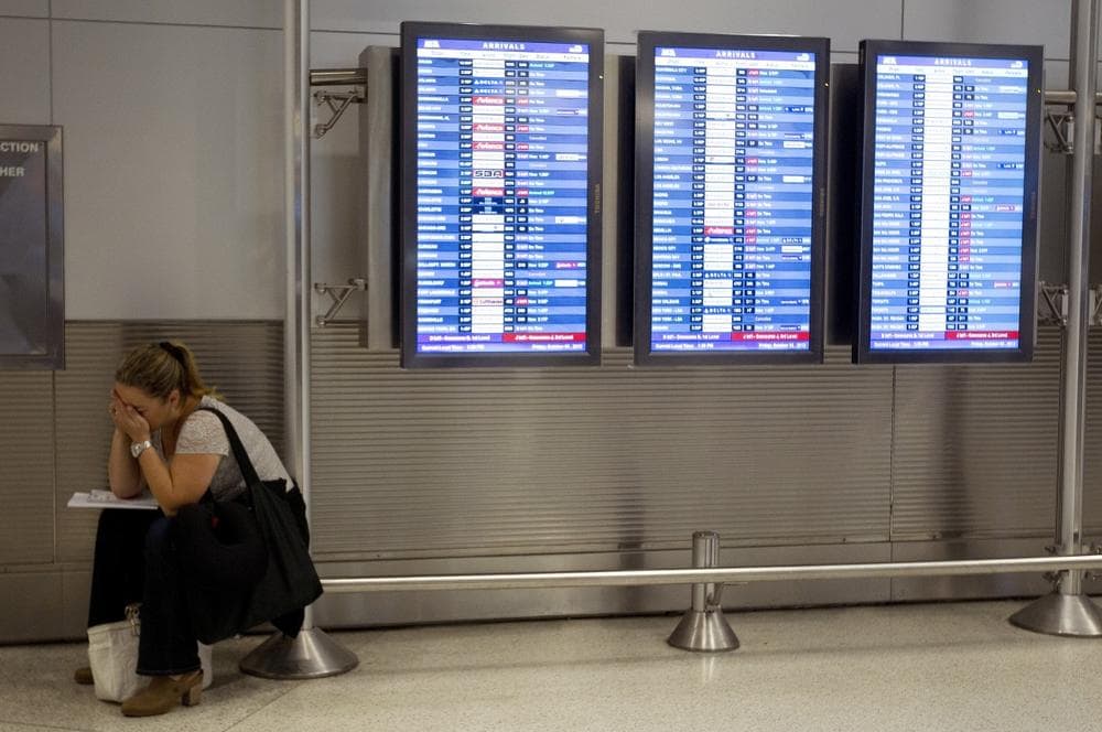 An unidentified American Airlines passenger is trying to make new flight arrangements after her flight was delayed. (AP/J Pat Carter)