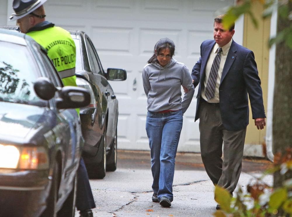 On Sept. 28, 2012, state chemist Annie Dookhan, was escorted to a police cruiser outside her Franklin, Mass. home. (AP/Bizuayehu Tesfaye)