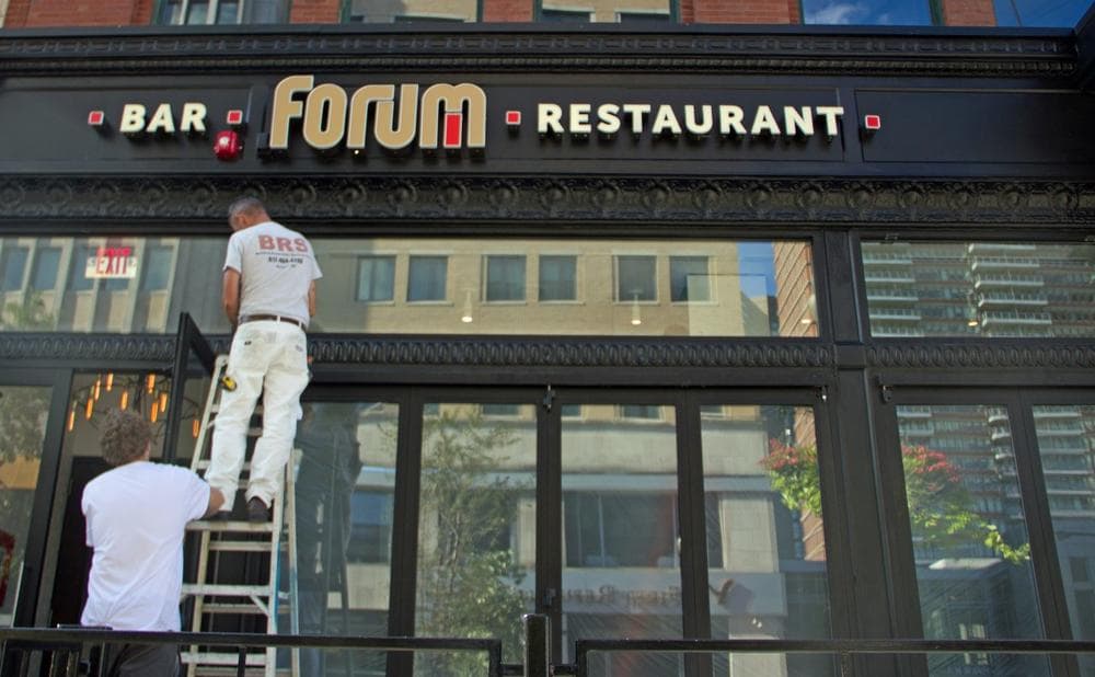 Workers paint the new sign of Forum Bar &amp;amp; Restaurant, the site of the second blast during the Boston Marathon on April 15. (Meghna Chakrabarti/WBUR)