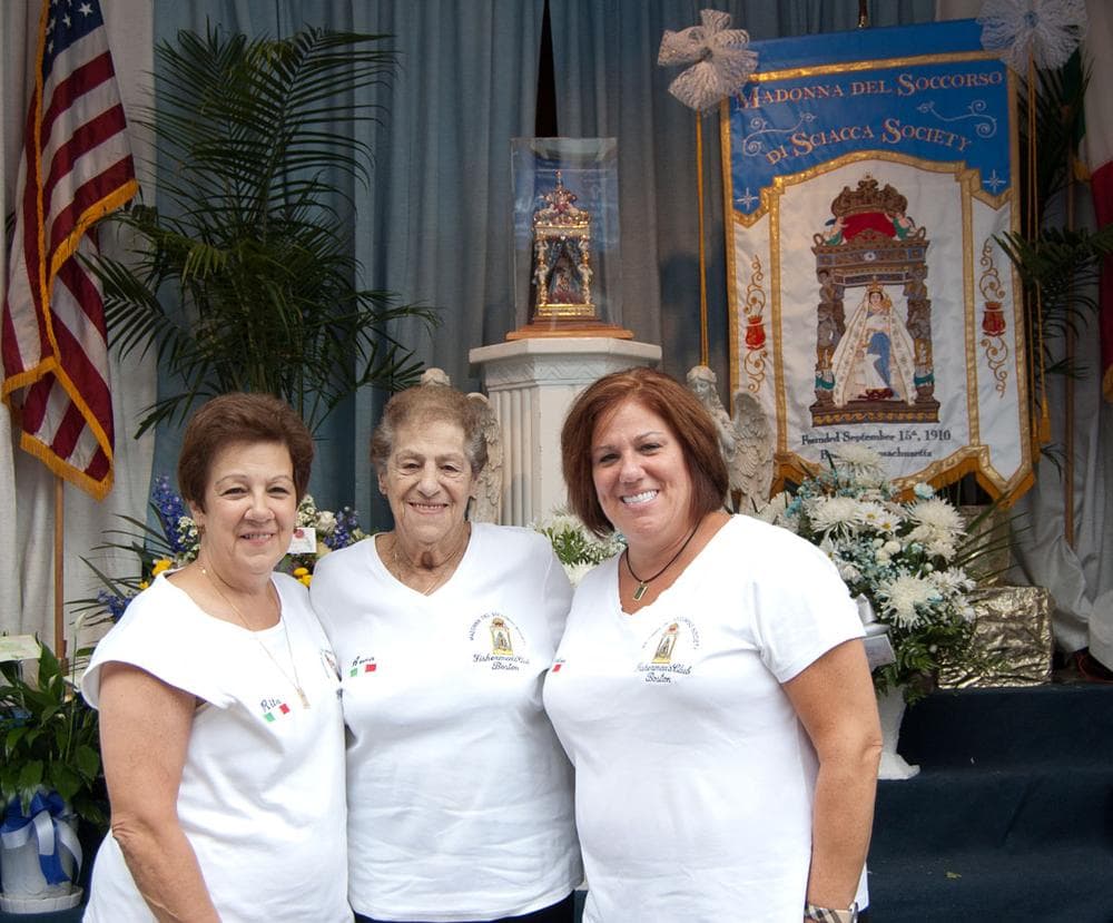 Anna Campo with her daughters Rita Sacco (left) and Nadine Solimine in front of the altar at the Madonna Del Soccorso di Sciacca Society. (Greg Cook/WBUR)
