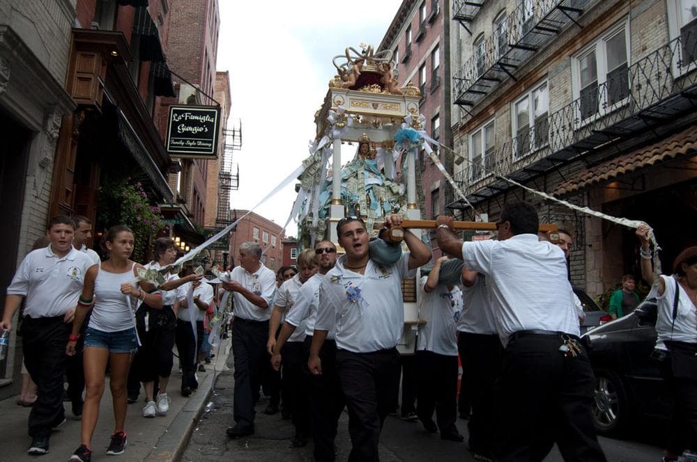 The Grand Procession” takes all Sunday afternoon and evening to snake through the streets of Boston’s North End accompanied by marching bands. (Greg Cook/WBUR)