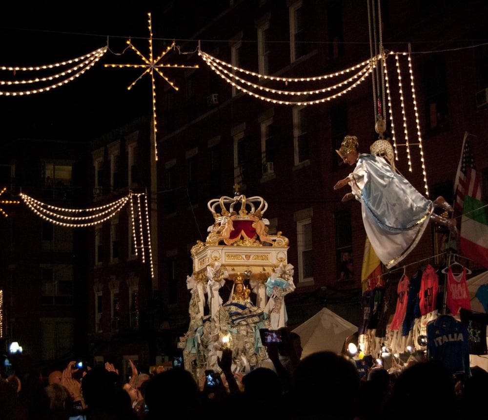 Flying angel Victoria Bono descends toward the statue of the Madonna Del Soccorso di Sciacca. (Greg Cook/WBUR)