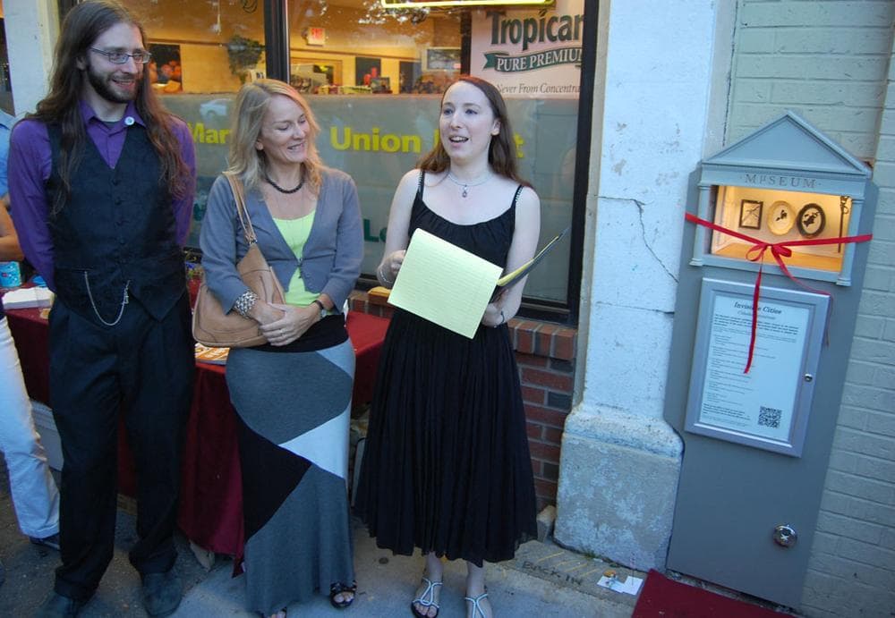 I’m really excited we have an opportunity here to show art being made in our community,” founding curator Judith Klausner told the crowd as (from left) “chief engineer” Steve Pomeroy and Rachel Strutt, program manager for the Somerville Arts Council, watched. (Greg Cook)