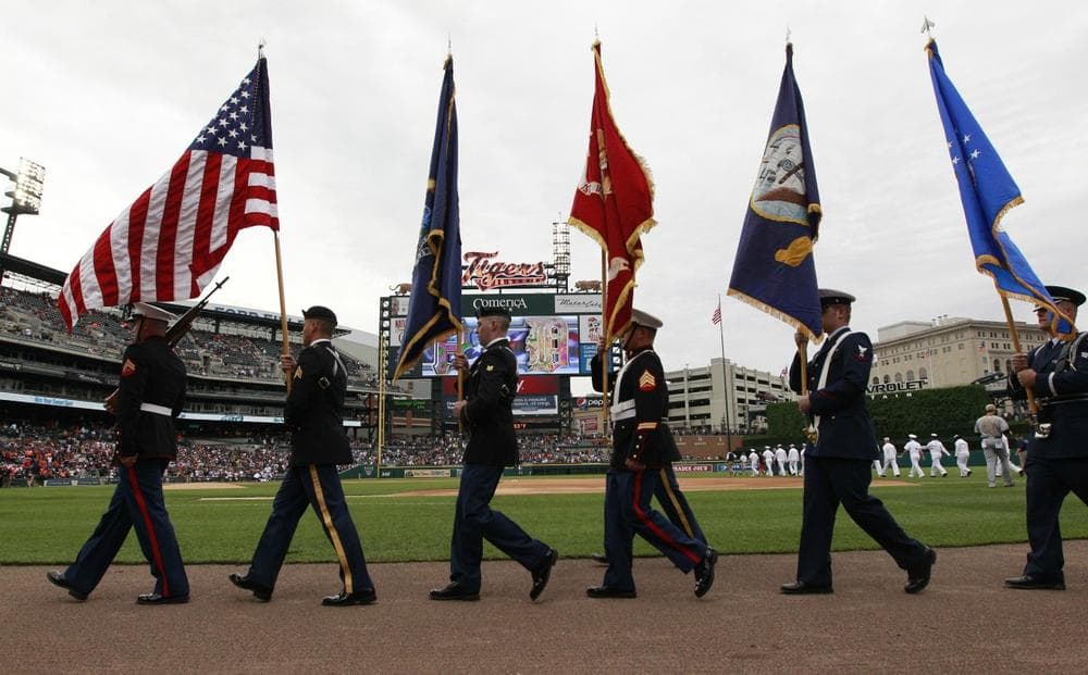 Members of the armed forces arrive for the national anthem before the baseball game between the Detroit Tigers and the Pittsburgh Pirates in Detroit, May 27, 2013. (Carlos Osorio/AP)