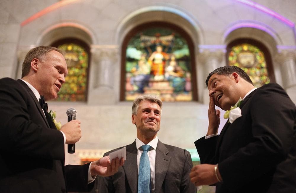 Minneapolis Mayor R.T. Rybak officiates the first gay wedding in Minnesota, between Jeff Isaacson (left) and Al Giraud (right), Aug. 1, 2013. (Stacy Bengs/AP)