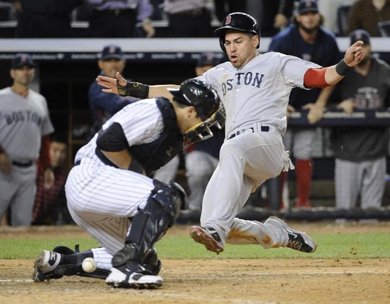 Jacoby Ellsbury scores on a single by Shane Victorino for the go-ahead run as New York Yankees catcher Austin Romine cannot handle the throw in the 10th inning. (AP)