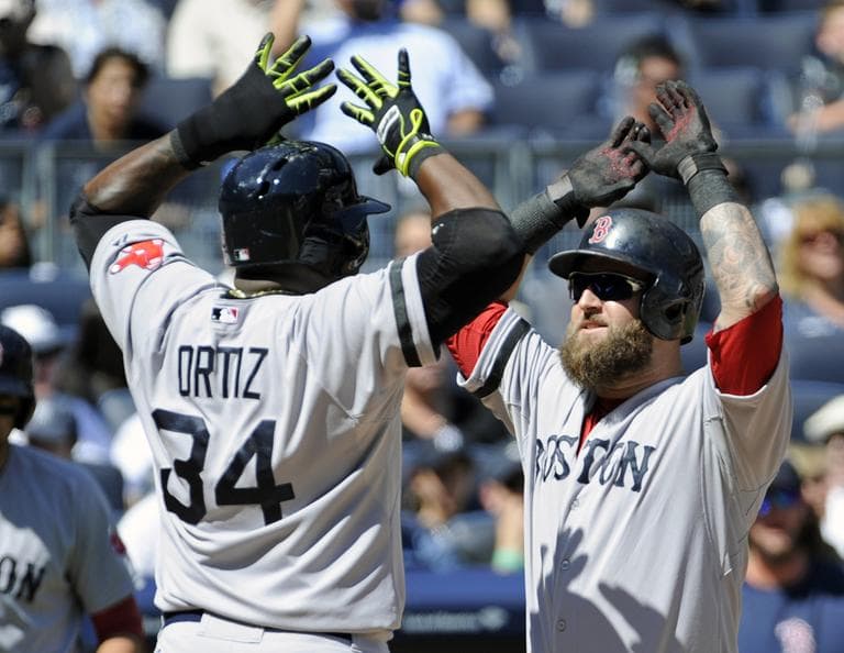 Boston Red Sox batter Mike Napoli, right, celebrates with David Ortiz after Napoli hit a two-run home run during the second inning of a baseball game against the New York Yankees Saturday, Sept. 7, 2013, at Yankee Stadium in New York. (Bill Kostroun/AP)