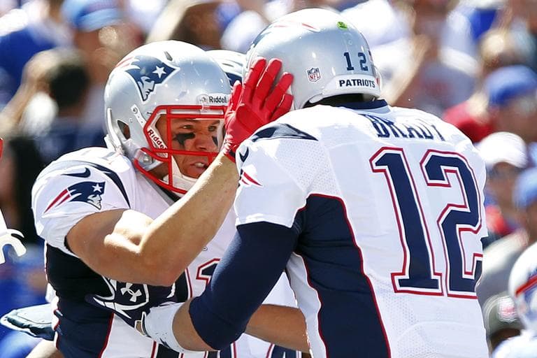 New England Patriots' Julian Edelman, left, celebrates with teammate Tom Brady, right, after catching a touchdown pass during the first half of an NFL football game against the Buffalo Bills, Sunday, Sept. 8, 2013, in Orchard Park. (Bill Wippert/AP)