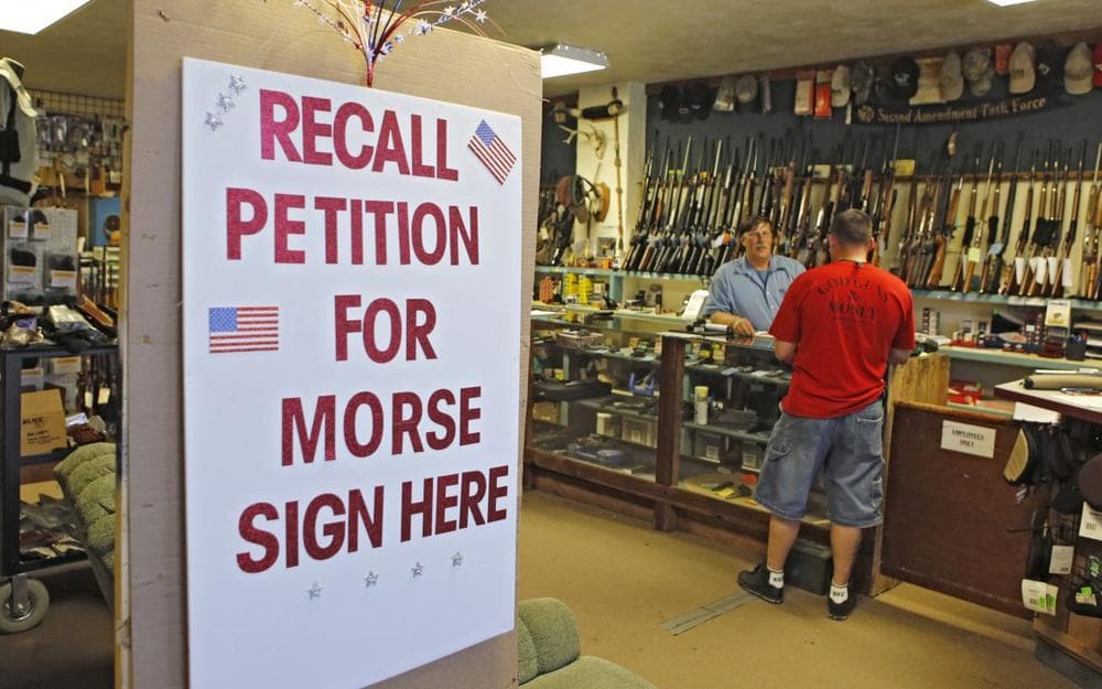 In this photo taken May 24, 2013, a large sign posted at the entrance of Paradise Firearms in Colorado Springs, Colo., invites customers to sign a recall petition against Colorado Democratic State Senate President John Morse. (Ed Andrieski/AP)