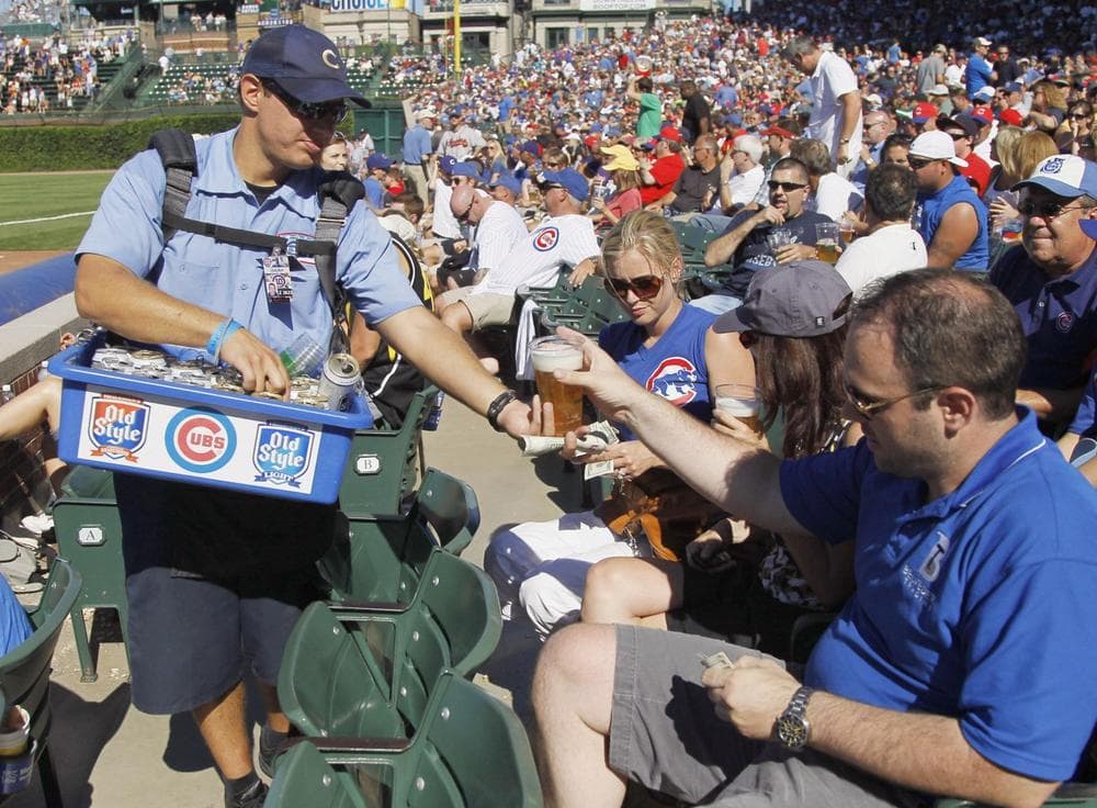A vendor sells an Old Style beer to a fan during a Chicago Cubs baseball game at Wrigley Field in Chicago on Aug. 25, 2011. (Charles Rex Arbogast/AP)