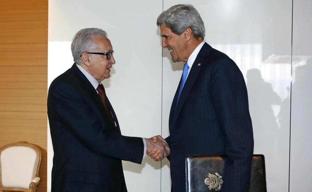 U.S. Secretary of State John Kerry, right, shakes hands with the U.N. Special Representative for Syria Lakhdar Brahimi in Geneva, Switzerland on Thursday, Sept. 12, 2013. (Larry Downing/AP)