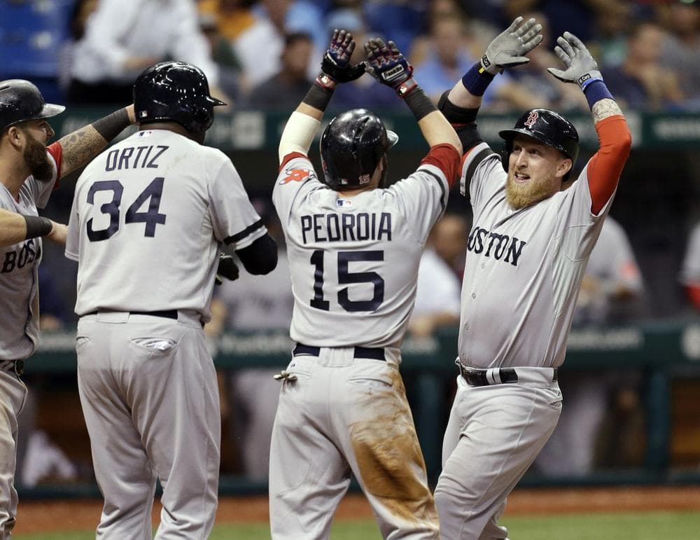Boston Red Sox's Mike Carp, right, celebrates with teammates, from left, Mike Napoli, David Ortiz, and Dustin Pedroia after his 10th-inning grand slam. (AP/Chris O'Meara)