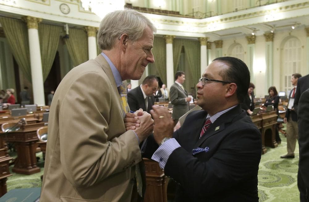 Assemblyman Luis Alejo, D-Watsonville, right, is congratulated by Assemblyman Roger Dickinson after the Assembly approved Alejo&#039;s minimum wage bill at the Capitol in Sacramento, Calif., Thursday, Sept. 12, 2013. The bill, AB10, which would raise the minimum wage from the current $8 an hour to $10 by 2016, now goes to the governor.(Rich Pedroncelli/AP)