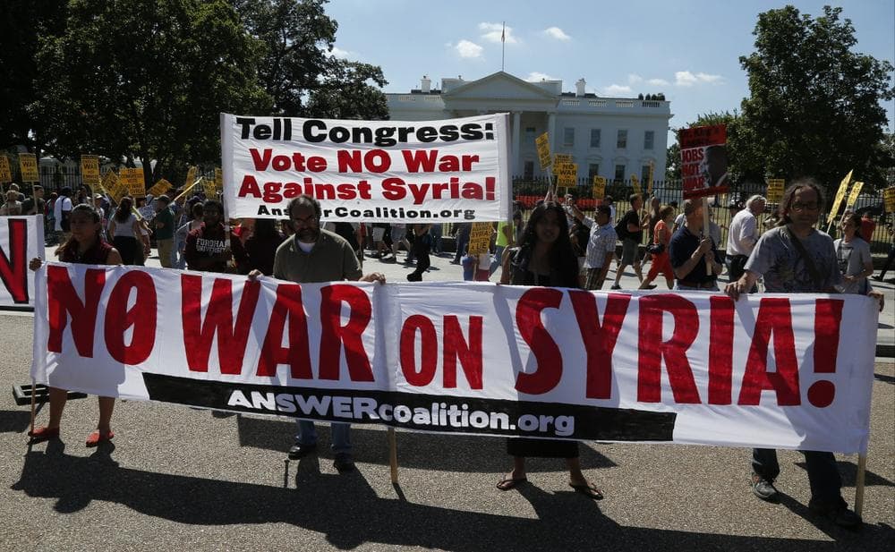 Anti-war demonstrators protest against possible U.S. military action in Syria in front of the White House in Washington, Saturday, Sept. 7, 2013. (Charles Dharapak/AP)