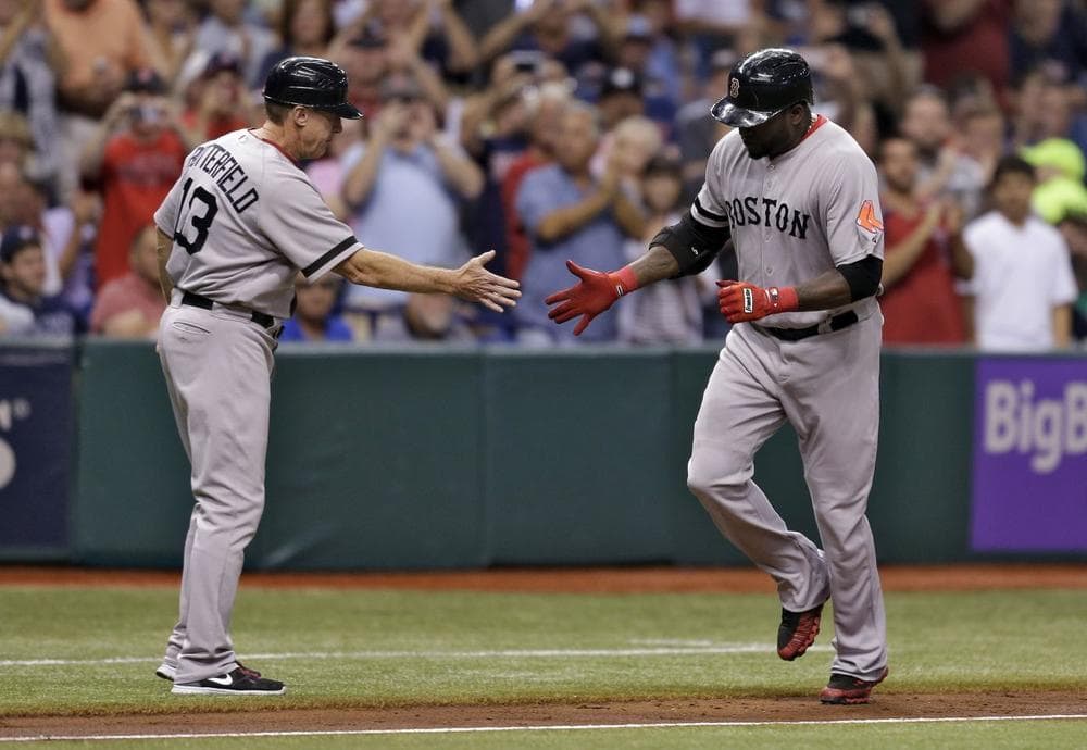 Boston Red Sox&#039;s David Ortiz, right, shakes nada with third base coach Brian Butterfield after his sixth-inning home run.  (AP/Chris O&#039;Meara)