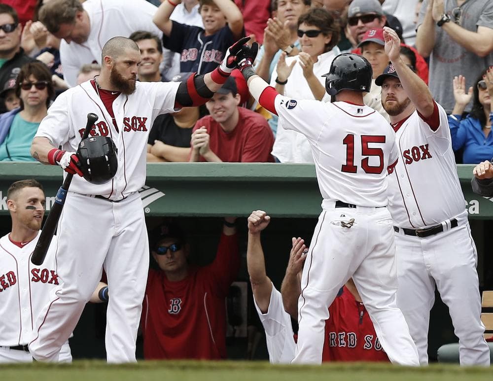 Dustin Pedroia (15) is congratulated by teammates Jonny Gomes, left, and starting pitcher Ryan Dempster, right, after scoring on a hit by David Ortiz in the third inning of Boston's 5-1 victory against the New York Yankees. (Winslow Townson/AP)