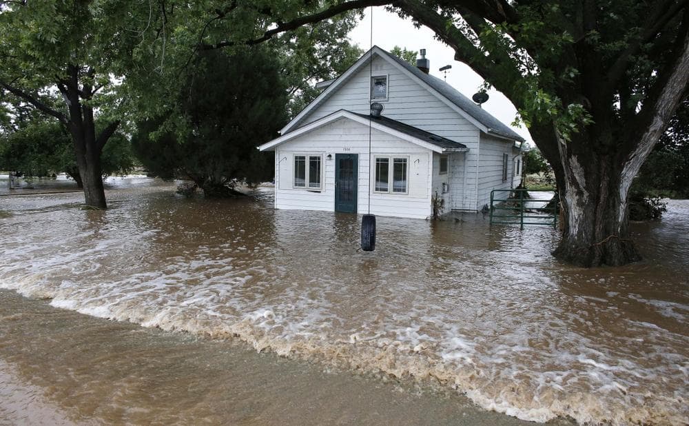 Water flows through an evacuated neighborhood after days of flooding in Hygeine, Colo., Sunday Sept. 15, 2013. (Brennan Linsley/AP)