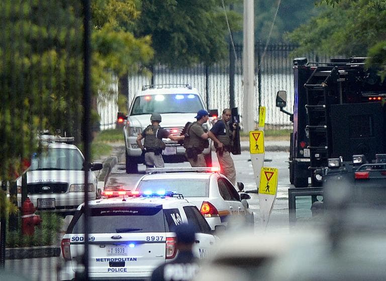 Law enforcement personnel are seen through the gate into the Washington Navy Yard Monday. (Susan Walsh/AP)