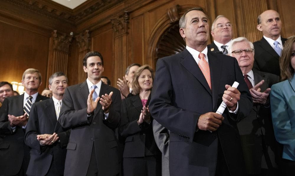 Speaker of the House John Boehner, R-Ohio, right, is cheered as Republican members of the House of Representatives rally after passing a bill that would prevent a government shutdown while crippling the health care law that was the signature accomplishment of President Barack Obama's first term, at the Capitol in Washington, Friday, Sept. 20, 2013. (J. Scott Applewhite/AP)