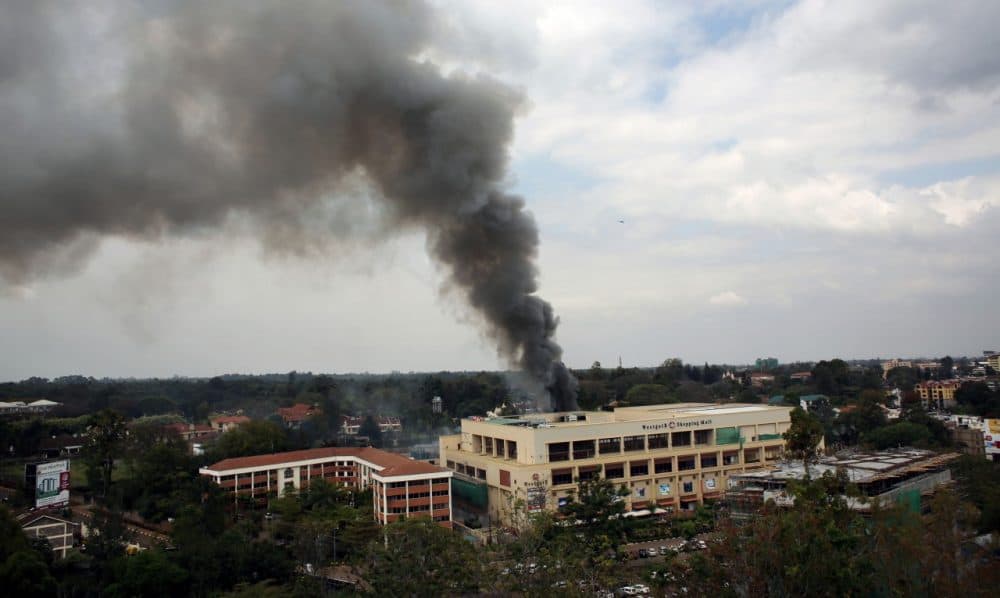 Heavy smoke rises from the Westgate Mall in Nairobi Kenya Monday Sept. 23 2013. Multiple large blasts have rocked the mall where a hostage siege is in its third day. (Jerome Delay/AP)