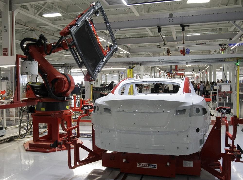 A robot puts on the top of a Tesla Model S at the Tesla factory in Fremont, Calif., Friday, June 22, 2012. The first Model S sedan car will be rolling off the assembly line on Friday. (AP Photo/Paul Sakuma)