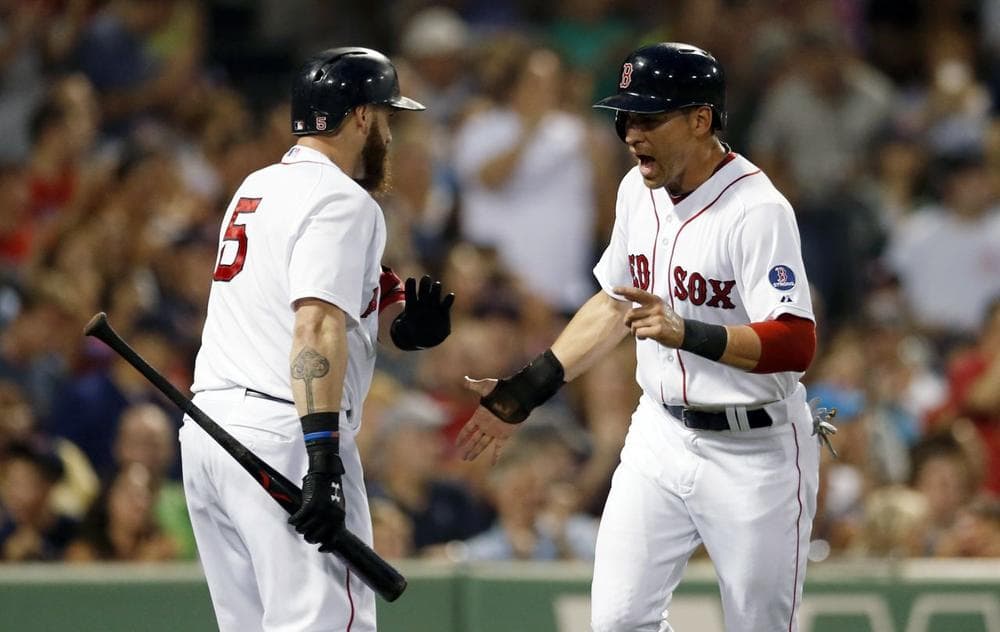 Boston Red Sox's Jacoby Ellsbury, right, celebrates with Jonny Gomes (5) after scoring on an RBI single by Mike Napoli in the first inning of a baseball game against the Chicago White Sox in Boston, Saturday, Aug. 31, 2013. (AP Photo/Michael Dwyer)