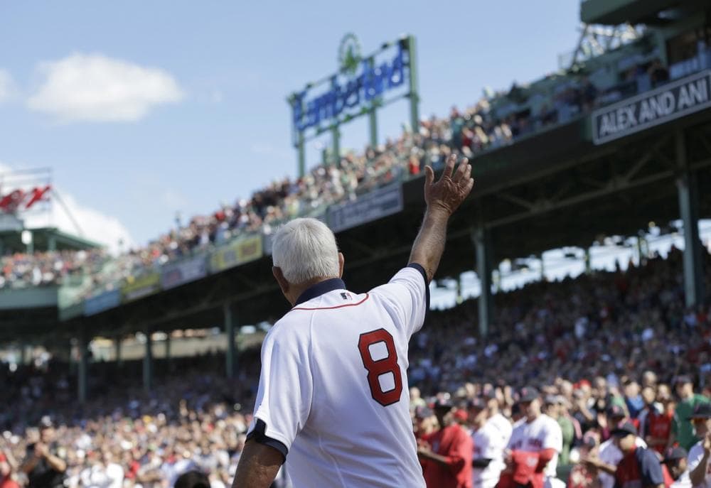 Hall of Famer Carl Yastrzemski waves to the crowd at Fenway Park, in Boston, Sunday, Sept. 22, 2013, before throwing out the ceremonial first pitch before a baseball game between the Toronto Blue Jays and the Boston Red Sox. Yastrzemski attended a ceremony held to unveil a statue of himself at Fenway Park earlier in the day. (AP Photo/Steven Senne)