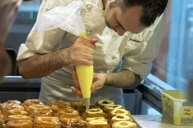 This June 3, 2013 photo shows chef Dominique Ansel making Cronuts, a croissant-donut hybrid, at the Dominique Ansel Bakery in New York. (AP)