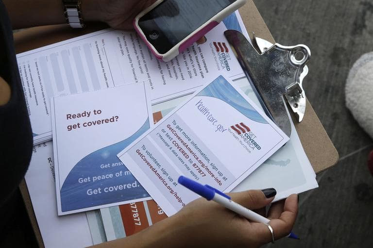Maygan Rollins, 22, a field organizer with Enroll America, holds a clipboard with pamplets while canvassing at a bus stop, Wednesday, Sept. 25, 2013, in Miami. Enroll America is a private, non-profit organization running a grassroots campaign to encourage people to sign up for health care offered by the Affordable Care Act. (AP)