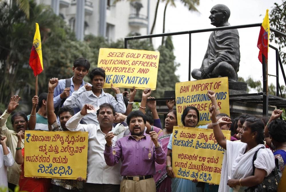 Indians protest asking the government to ban the import of gold, in Bangalore, India, Saturday, Sept. 7, 2013 as India's new central bank chief Raghuran Rajan announced measures to boost confidence as the troubled Indian economy slows and the currency tumbles. (AP)