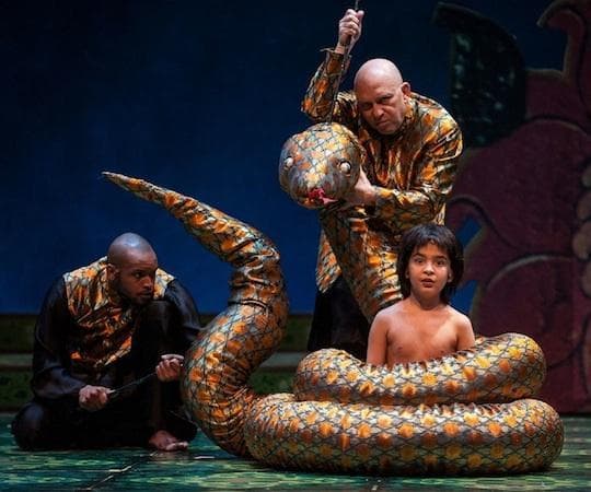 Timothy Wilson and Akash Chopra encircled by a snake manipulated by Thomas Derrah in &quot;The Jungle Book.&quot; (Liz Lauren)