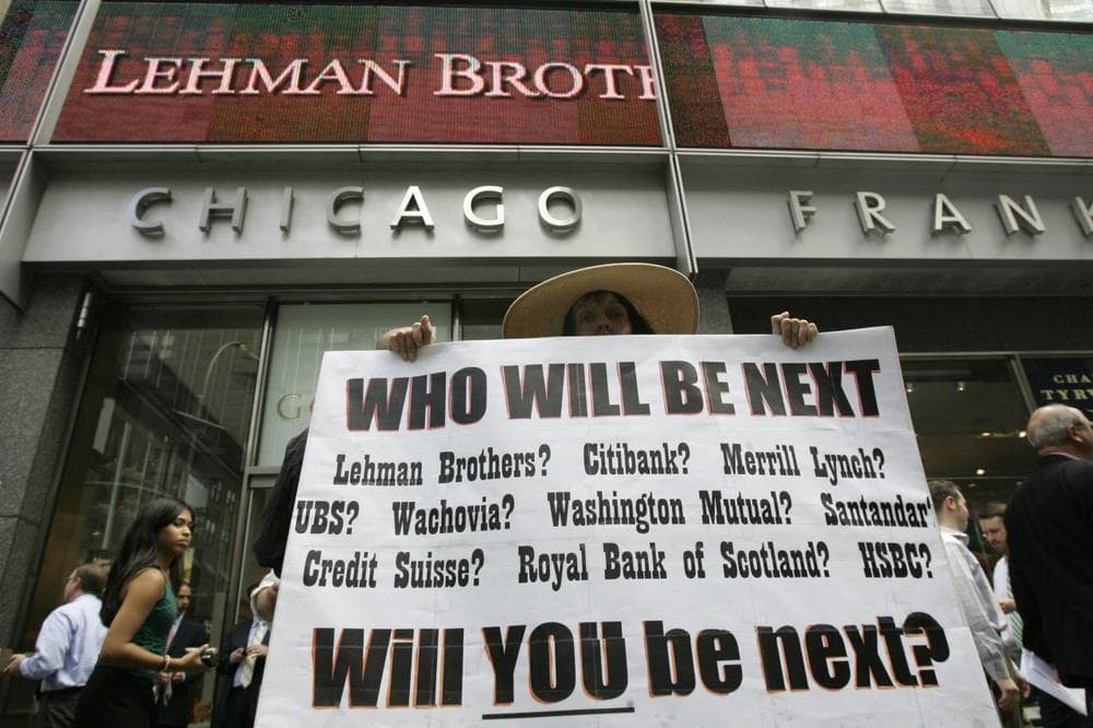 Robin Radaetz holds a sign in front of the Lehman Brothers headquarters Monday, Sept. 15, 2008 in New York. Lehman Brothers, a 158-year-old investment bank choked by the credit crisis and falling real estate values, filed for Chapter 11 protection five years ago. (AP)