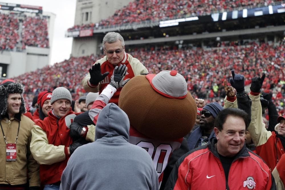 Former Ohio State University head coach Jim Tressel is carried by the members of his 2002 national championship team between quarters of an NCAA college football game between Ohio State and Michigan Saturday, Nov. 24, 2012, in Columbus, Ohio. (AP)
