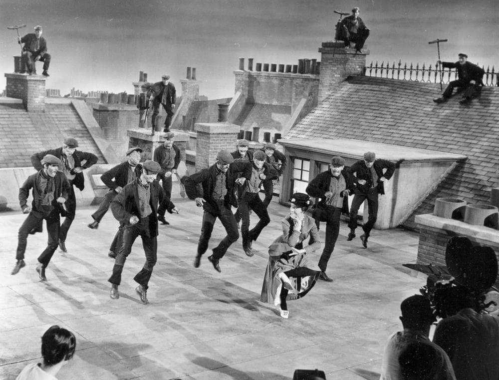 Actress Julie Andrews dances with the chimney sweeps in the chimney-sweep dance number during filming of &quot;Mary Poppins&quot; on a movie set representing London rooftops at the Disney Studios in Hollywood, Ca., Aug. 16, 1963. (AP)