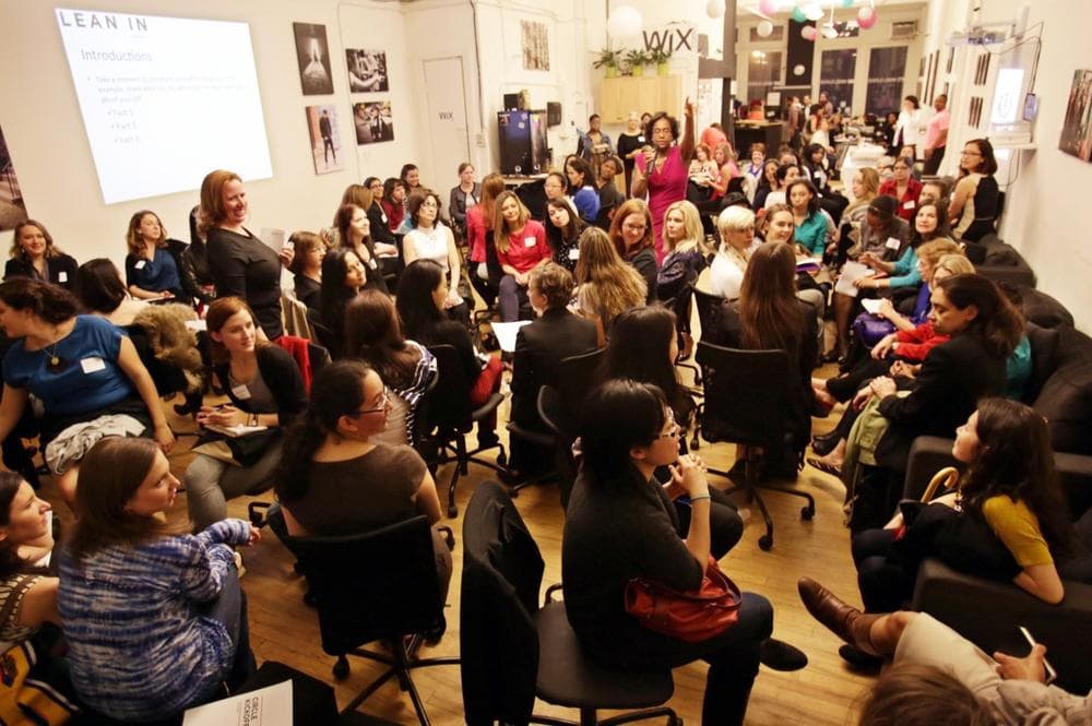 This April 16, 2013 photo provided by Wix Lounge shows group facilitator Franne McNeal, right, standing, and organizer Mary Dove, standing left, addressing women at a &quot;Lean In&quot; meeting in New York. The group is inspired by Facebook COO Sheryl Sandberg's book &quot;Lean In&quot; which seeks to empower women in the workplace. (AP Photo/Wix Lounge, Galo Delgado)