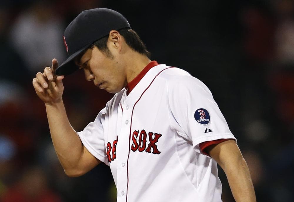 Red Sox closer Koji Uehara reacts after giving up a run to the Baltimore Orioles in the ninth inning on Tuesday. (AP/Elise Amendola)