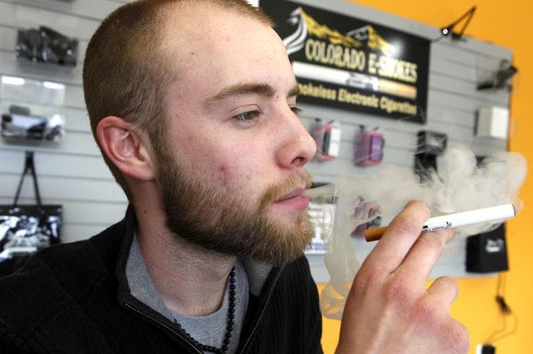 This photo taken on Wednesday, March 2, 2011, shows Blair Roberts, a 22-year-old sales associate at Colorado E-Smokes as he demonstrates the use of a electronic cigarette and the smoke like vapor that comes from it at an E-Smokes store in Aurora, Colo. (AP)