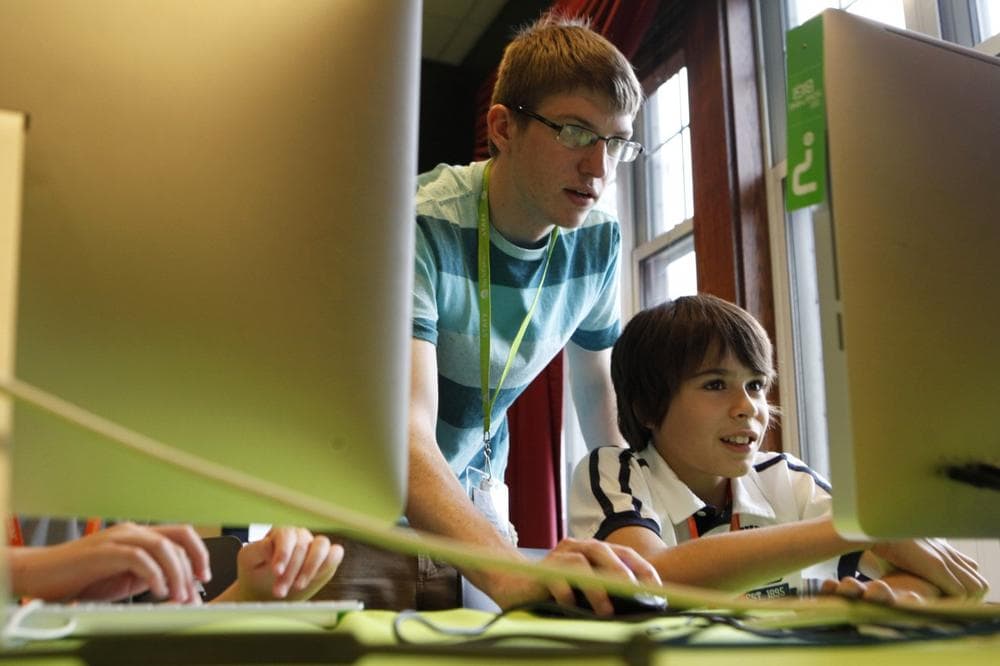 Thaddeus Owings, left, helps camper Nicholas Sanchez work on creating a video game while at an iD Tech Camp at the Emory University campus. (AP/Jaime Henry-White)
