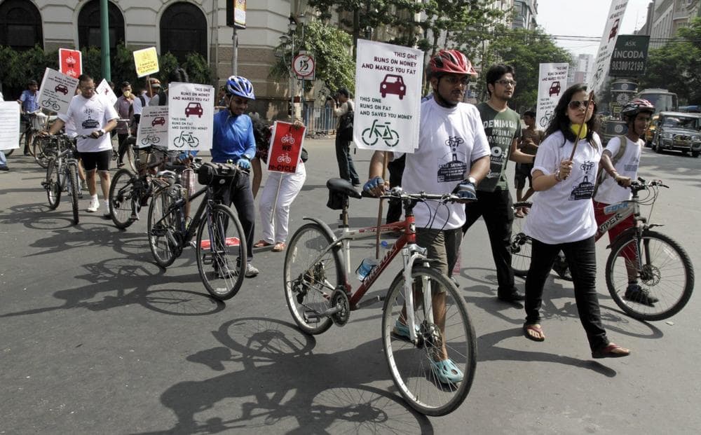 Activists march with bicycles and posters during an awareness rally on environment friendly non-polluting transport in Kolkata, India, Sunday, Sept. 8, 2013. The activists demanded that the authorities withdraw the restrictions on cycles and other non-motorized transport in Kolkata’s main streets. (Bikas Das/AP)