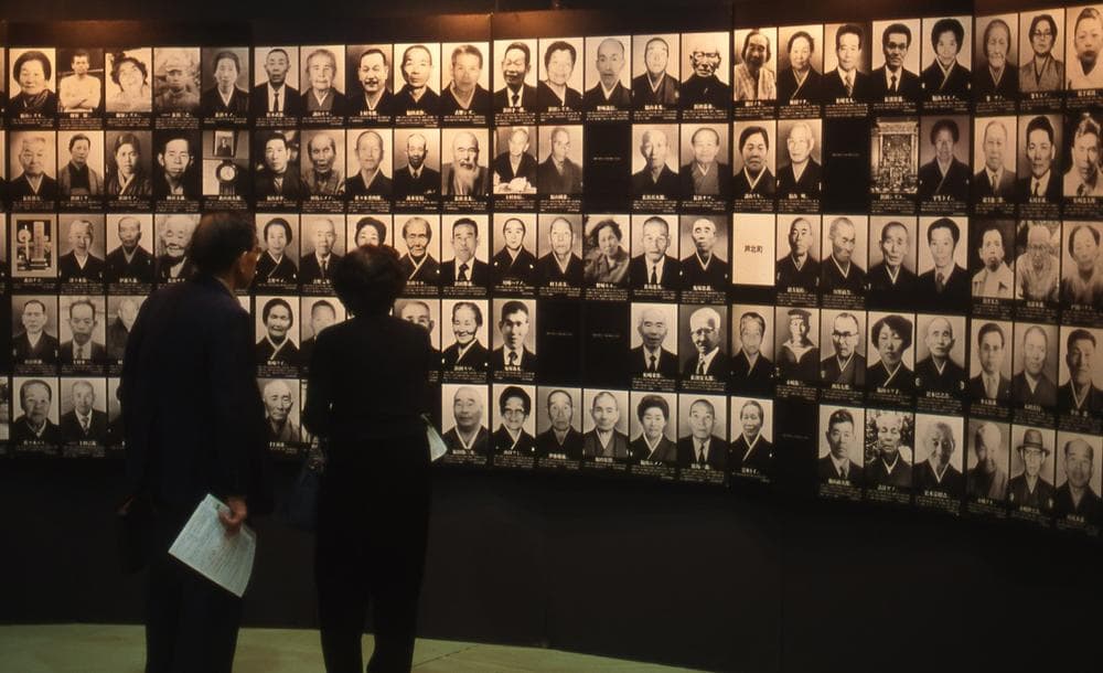 Visitors viewing photographs of deceased Minamata disease victims displayed at the Minamata Tokyo Exhibition in 1996 (Timothy S. George)