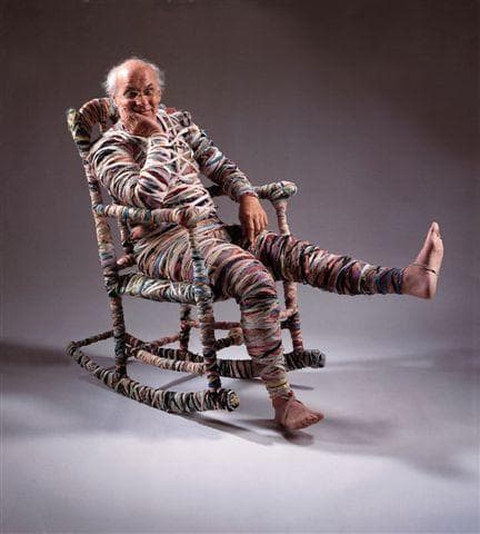 Artist Tommy Simpson sits in his “mummified” chair. (William Seitz/Fuller Craft Musuem)