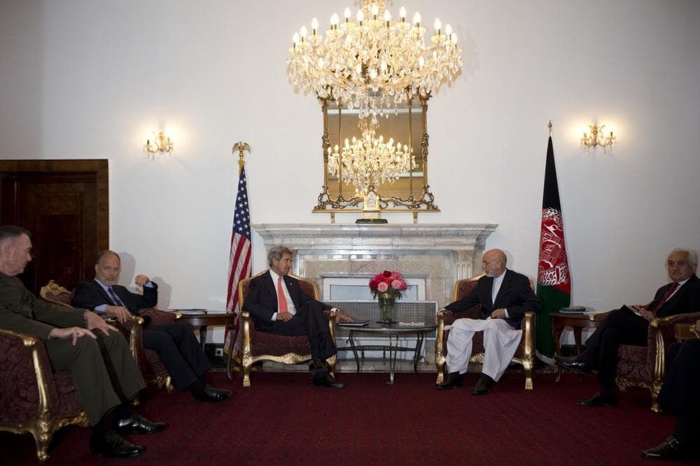 U.S. Secretary of State John Kerry, center left, meets with Afghan President Hamid Karzai at the presidential palace during an unannounced stop in Kabul, Afghanistan, Friday, Oct. 11, 2013. Kerry flew to Afghanistan Friday for urgent talks with Afghan President Hamid Karzai as an end of October deadline looms for completing a security deal that would allow American troops to remain in Afghanistan after the end of the NATO-led military mission next year. (Jacquelyn Martin/AP)